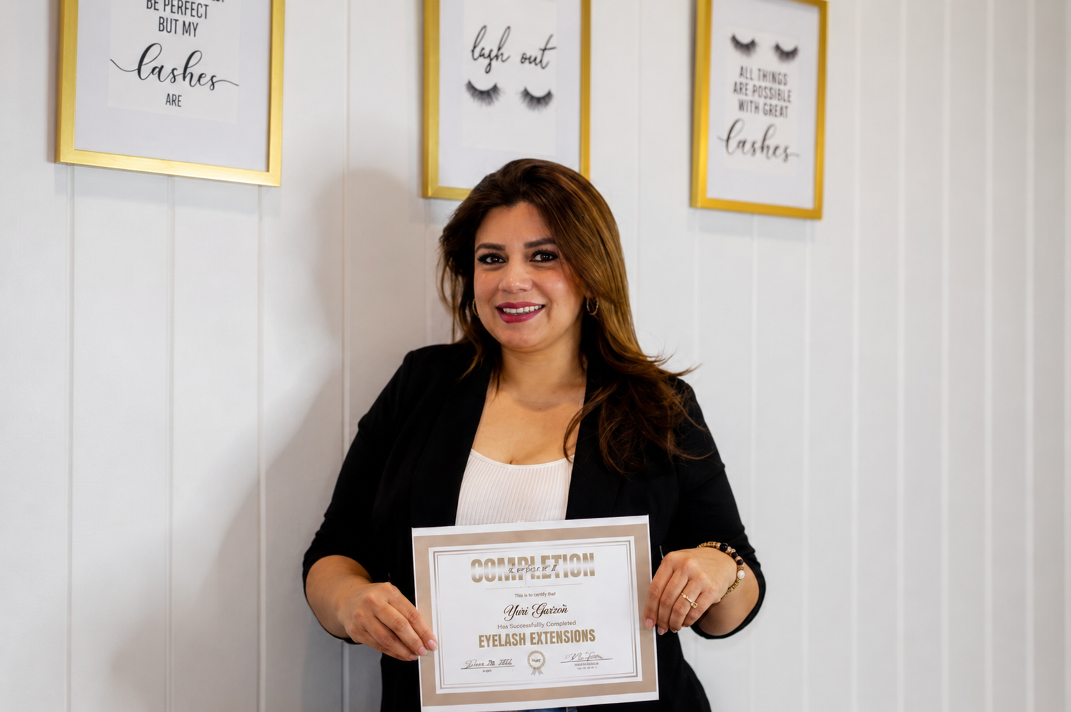 Yuri holding her certificate of completion in eyelash extensions